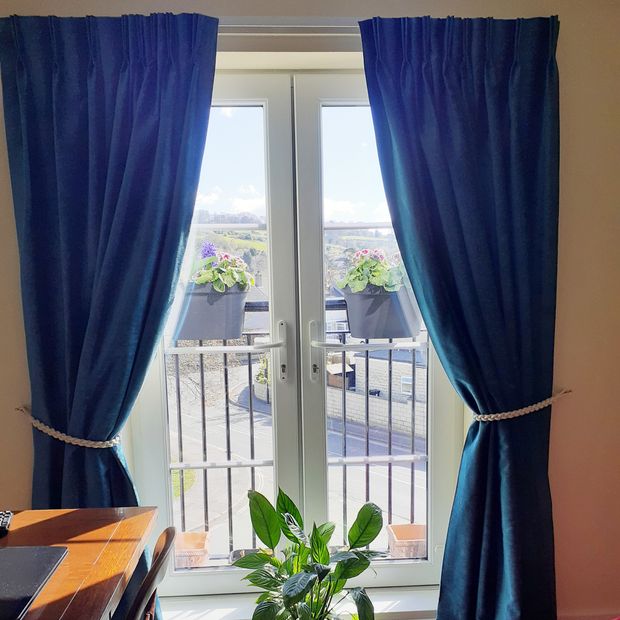 Darcia velvet teal velvet curtains fitted over bedroom balcony doors