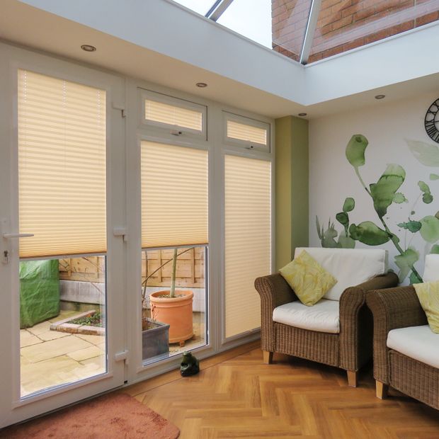 INTU micro infusion beige pleated blinds in conservatory