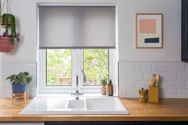 reber ash roller blind in kitchen window above white sink