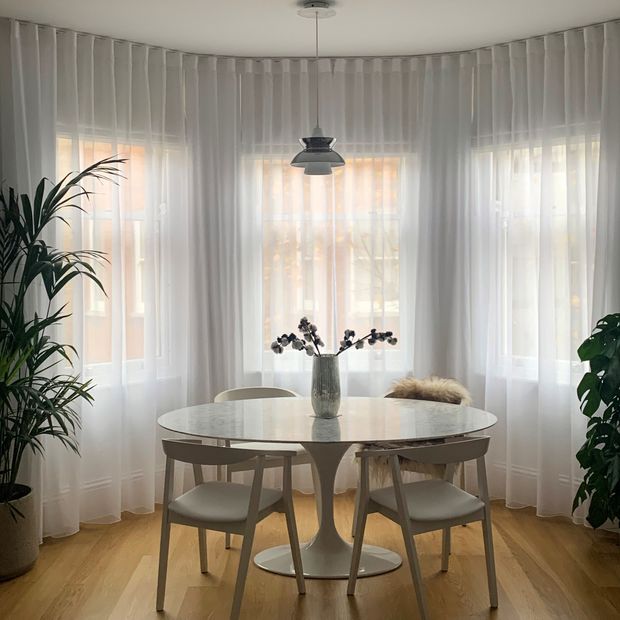 Serenity chalk wave header voile curtain on a bay window in dining room