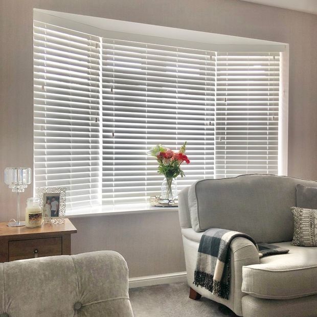 Haywood pure white wood venetian blinds in a living room bay window