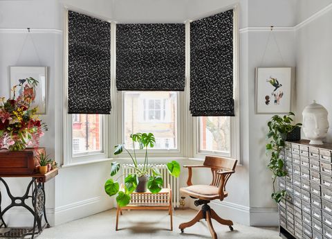 Vapour obsidian roman blinds in living room bay window