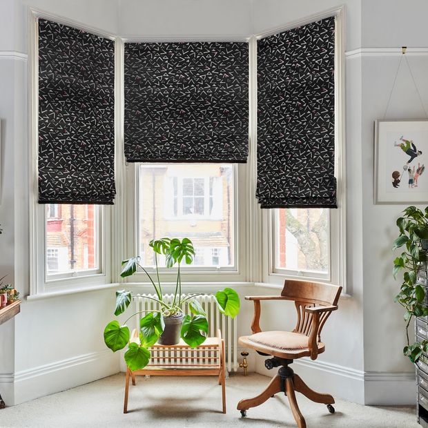 Vapour obsidian roman blinds in living room bay window