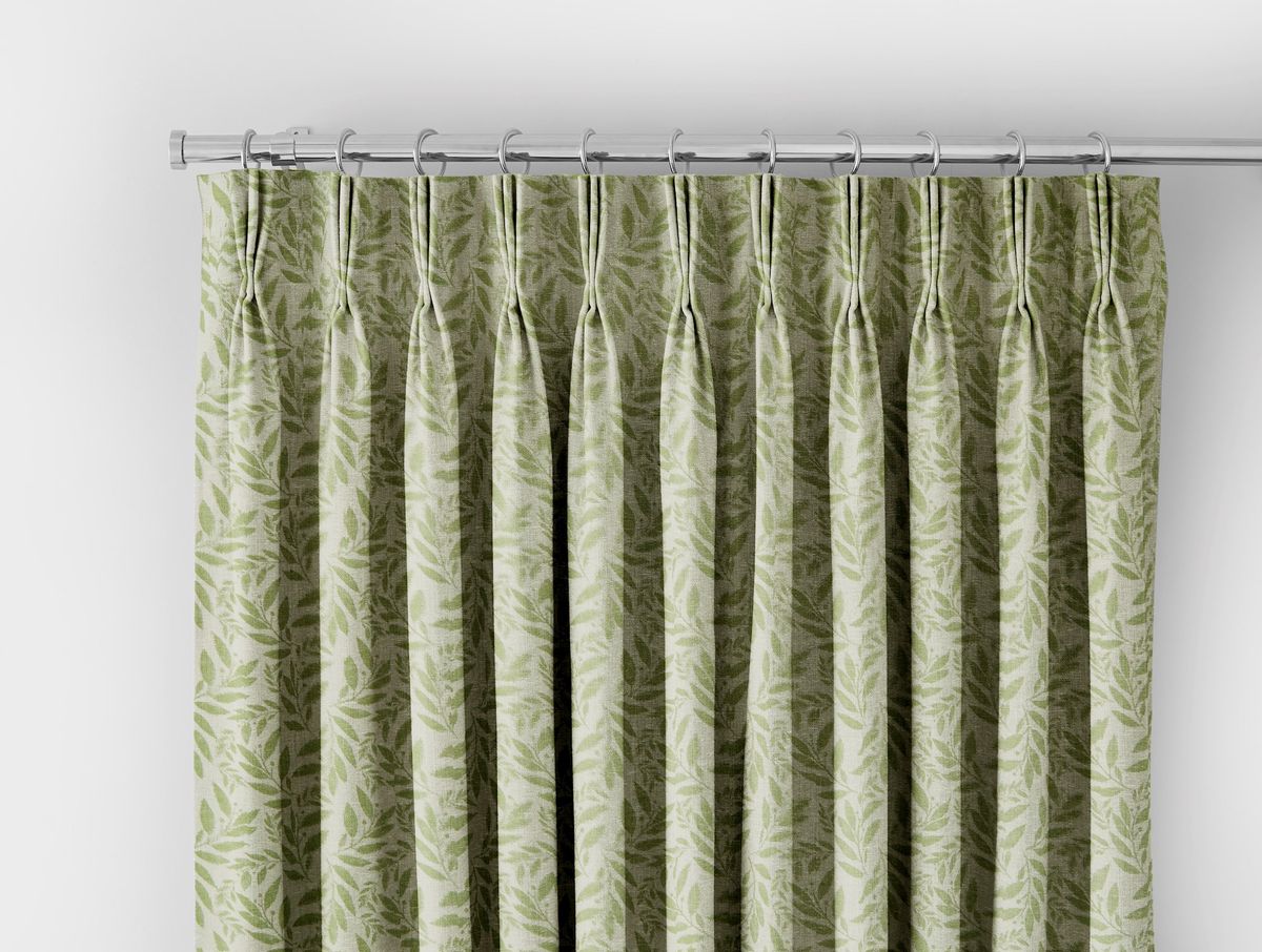 light green curtain with darker green leaf pattern header on a silver curtain pole