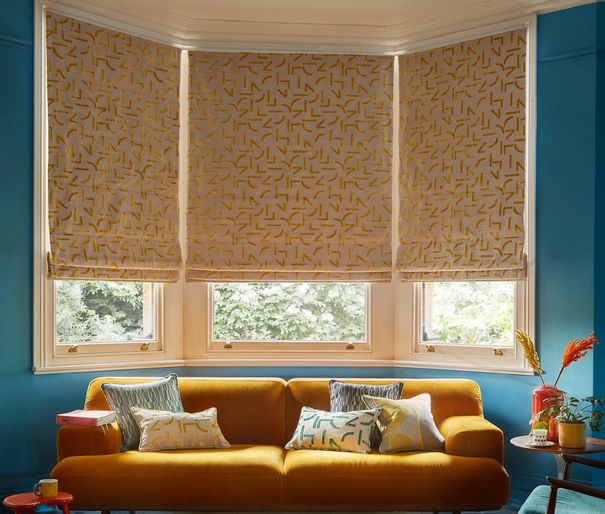 mori ochre margo selby roman blinds in bay window in living room