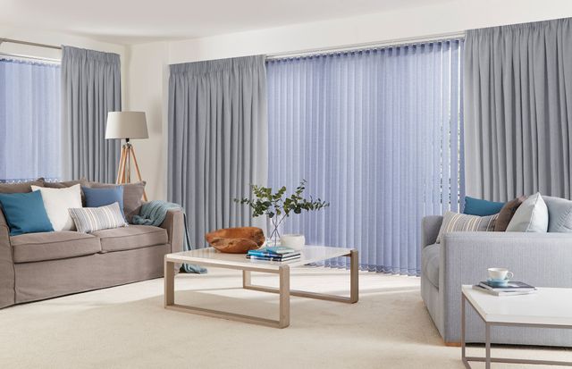 harper mallow curtains paired with blue vertical blinds in living room