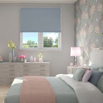 Plain Acacia Blue roller blind hung in bedroom