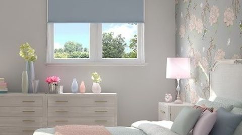 Plain Acacia Blue roller blind hung in bedroom