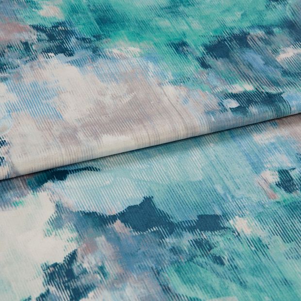 A folded piece of fabric with Aurora Pacific Teal printed on it