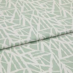 A folded piece of fabric with Alder Celadon Teal printed on it