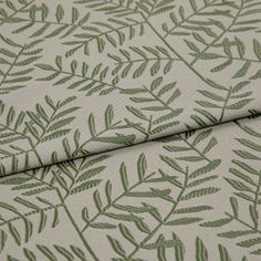 A folded piece of fabric with Fronds Fir Yellow printed on it