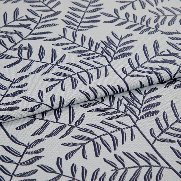 A folded piece of fabric with Fronds Navy Blue printed on it