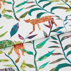 A folded piece of fabric with Hide & Seek Jungle Green printed on it
