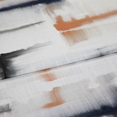 A folded piece of fabric with Expression Canyon Orange printed on it