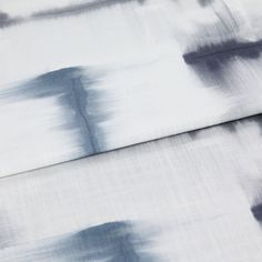 A folded piece of fabric with Expression Sky Blue printed on it