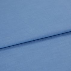 A folded piece of fabric with Faso Cornflower Blue printed on it