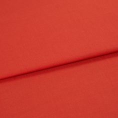A folded piece of fabric with Faso Fiesta Red printed on it