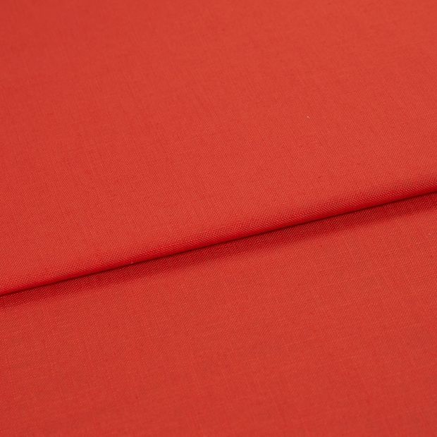 A folded piece of fabric with Faso Fiesta Red printed on it