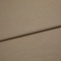 A folded piece of fabric with Faso Taupe Brown printed on it