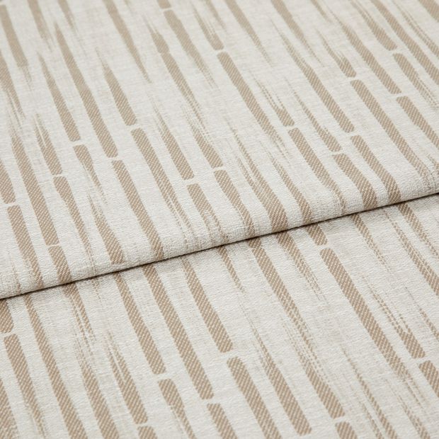 A folded piece of fabric with Flourish Taupe Natural printed on it