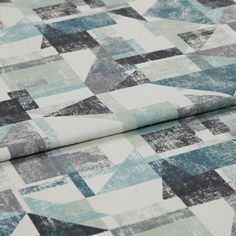 A folded piece of fabric with Fraction Teal printed on it