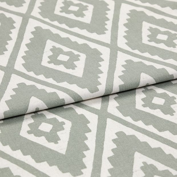 A folded piece of fabric with Mali Seagrass Light Green printed on it