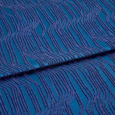 A folded piece of fabric with Maud Indigo Blue printed on it