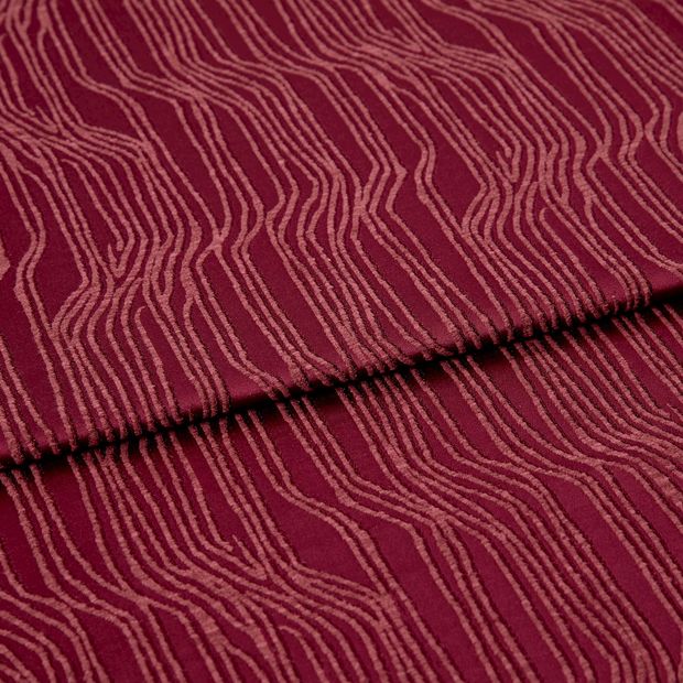 A folded piece of fabric with Maud Ruby Red printed on it