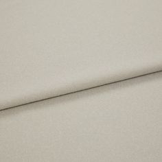 A folded piece of fabric with Huxley Sandbar Silver printed on it