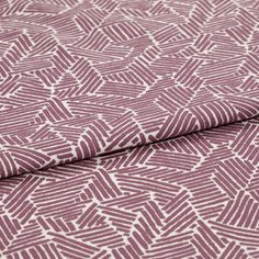 A folded piece of fabric with Parquet Berry Purple printed on it
