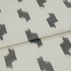 A folded piece of fabric with Patara Phantom Grey printed on it