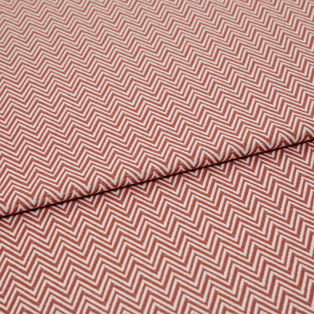 A folded piece of fabric with Pippa Coral Red printed on it
