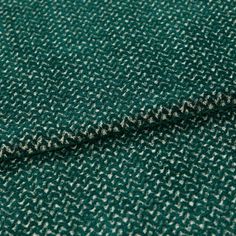 A folded piece of fabric with Wave Emerald Green printed on it