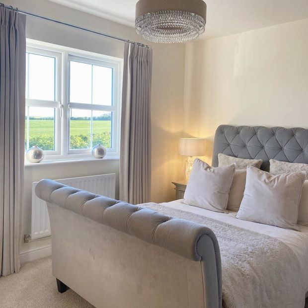 Grey curtains in minimalist grey/cream bedroom
