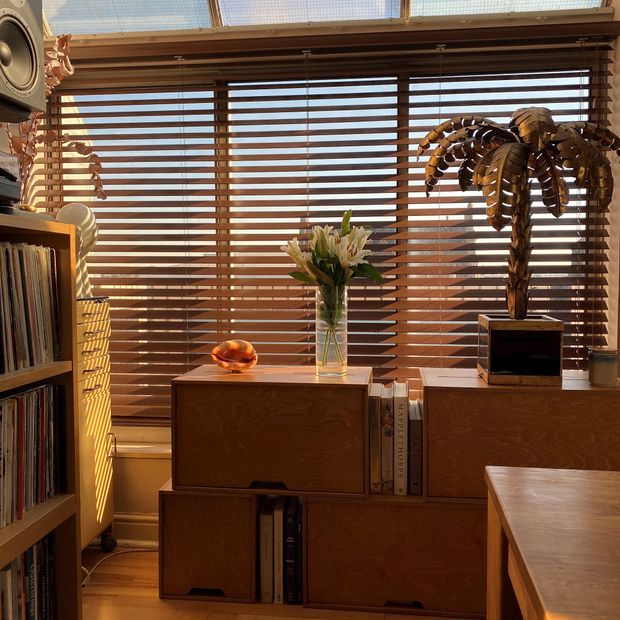 brown antique oak wooden blinds in living room with sun streaming in through the windows