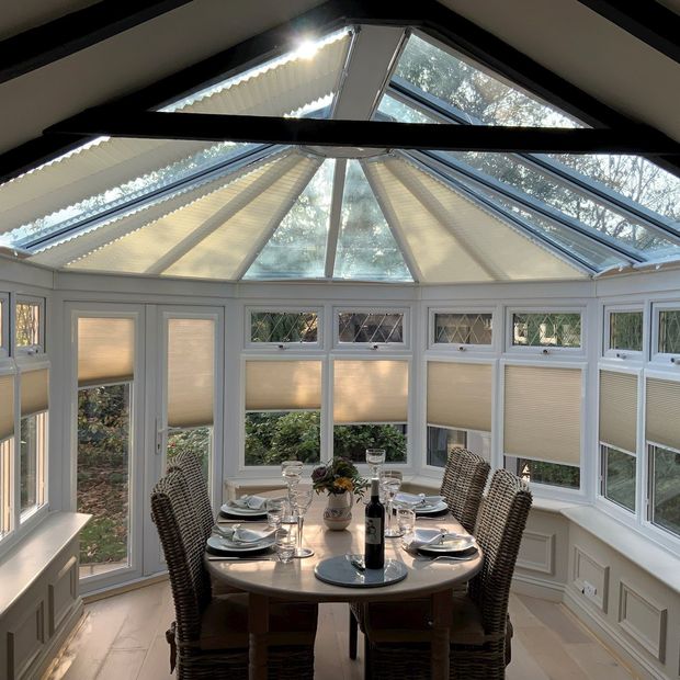 Alayna Natural pleated blinds on conservatory side windows and roof