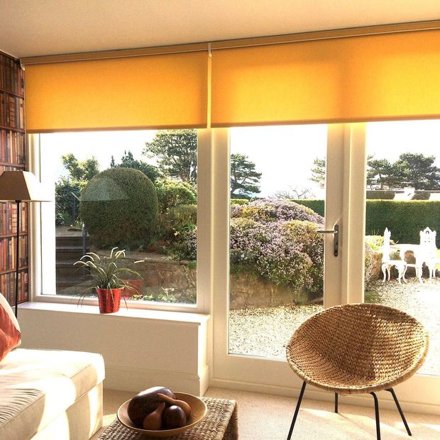 Acacia buttercup roller blinds on patio doors in living room