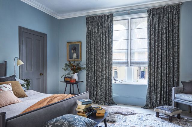 Anika Grey floor length pinch pleat curtains paired with voile roman blinds in bedroom