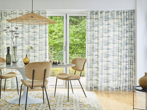 Mist slate patterned wave curtains on patio doors in dining room