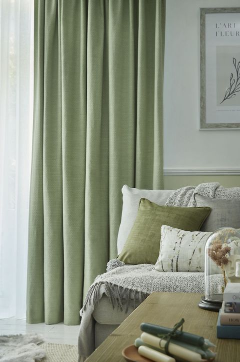 Pearl olive green floor length pinch pleat curtains paired with voiles in cosy living room