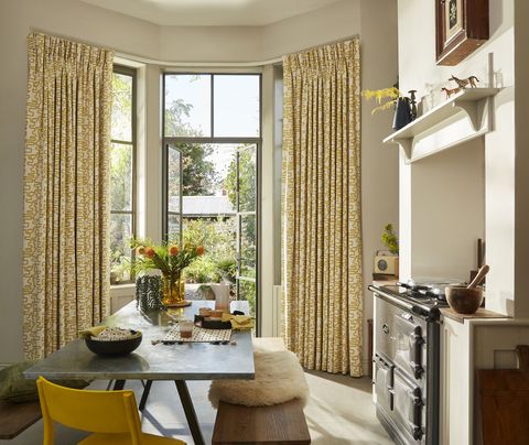 Wirl chartreuse yellow patterned curtains on bay window patio doors in kitchen/dining area