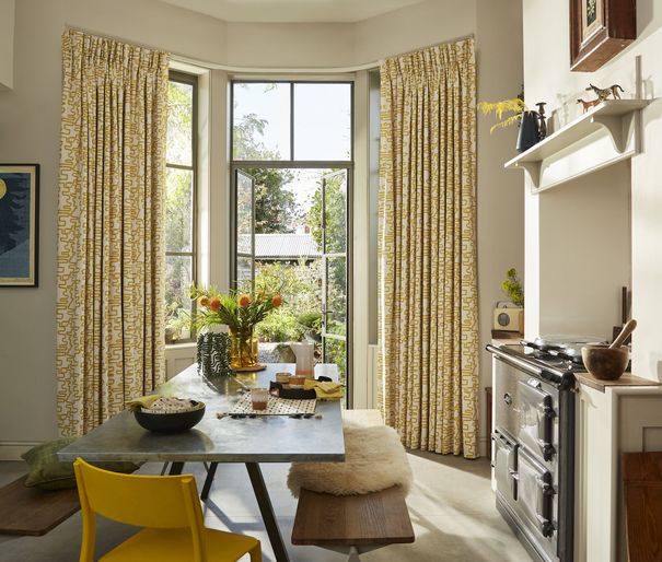 Wirl chartreuse yellow patterned curtains on bay window patio doors in kitchen/dining area