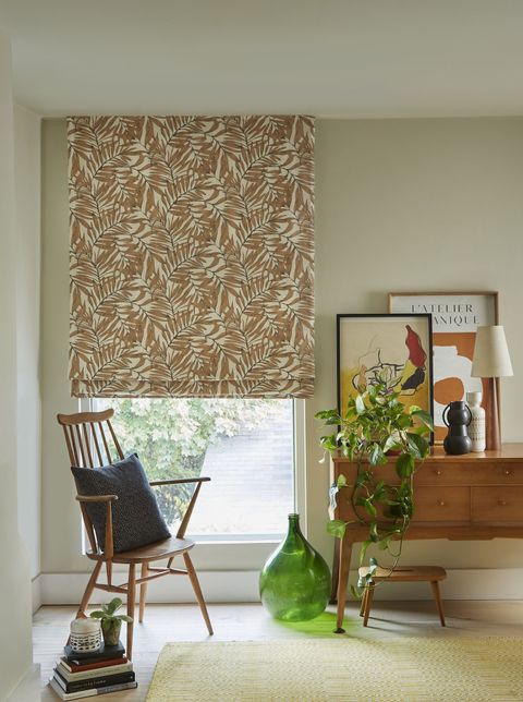 Laurel rust patterned roman blinds in bedroom with desk and armchair