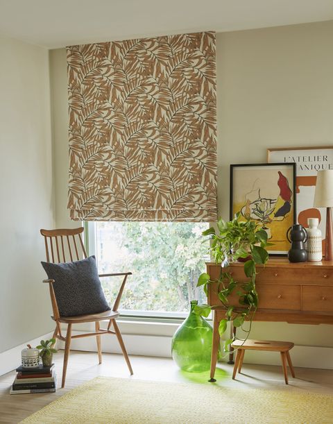 Laurel rust patterned roman blinds in bedroom with desk and armchair