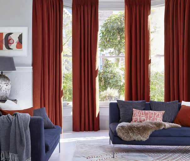 Two pairs of soho boucle spice pinch pleat curtains in bay window in living room