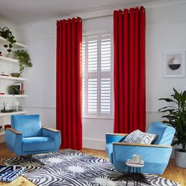 Faso fiesta floor length eyelet curtains paired with white shutters in modern living room