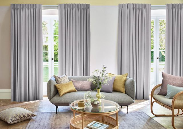 Two sets of bailey lavender fog curtains in open floral themed living room