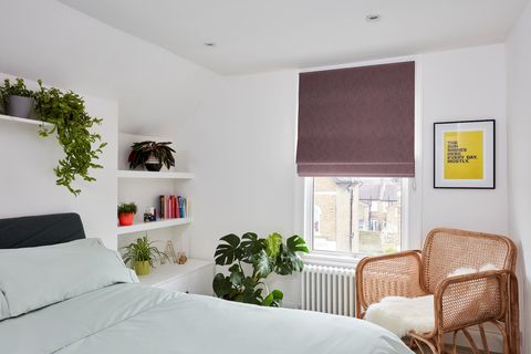 Boheme plum roman blind in minimalistic bedroom with wicker chair