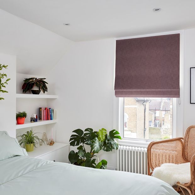 Boheme plum roman blind in minimalistic bedroom with wicker chair