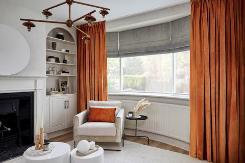 Darcia velvet cointreau floor length curtains paired with grey roman blinds in living room